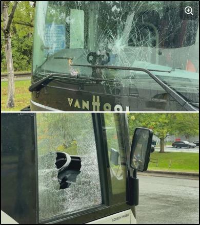 Broken windows on buses used to transport asylum seekers and migrants in Hampshire, England.